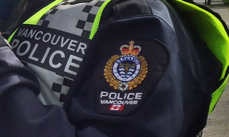 Vancouver Police Department logo on an officer's jacket sleeve.