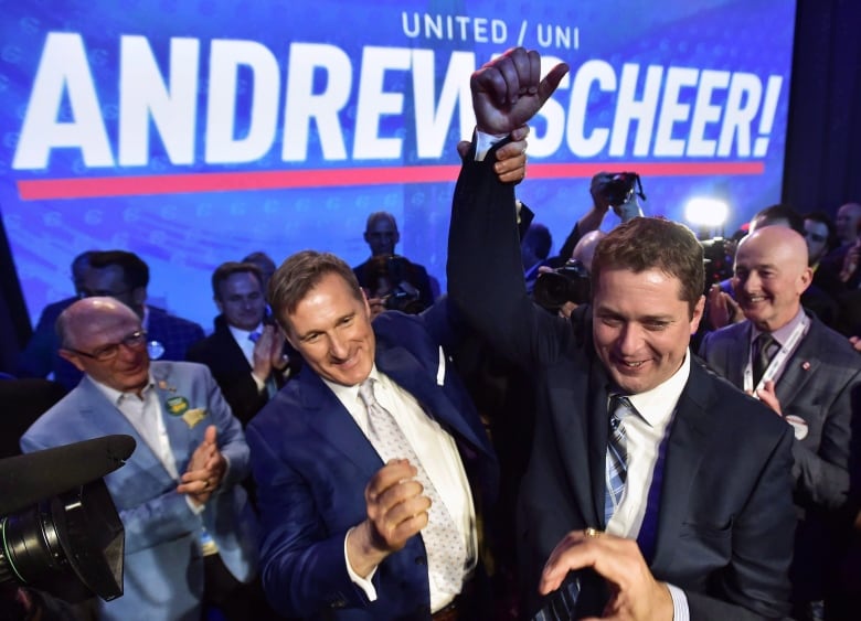 Andrew Scheer, right, is congratulated by Maxime Bernier after being elected the new leader of the federal Conservative party at the federal Conservative leadership convention in Toronto.