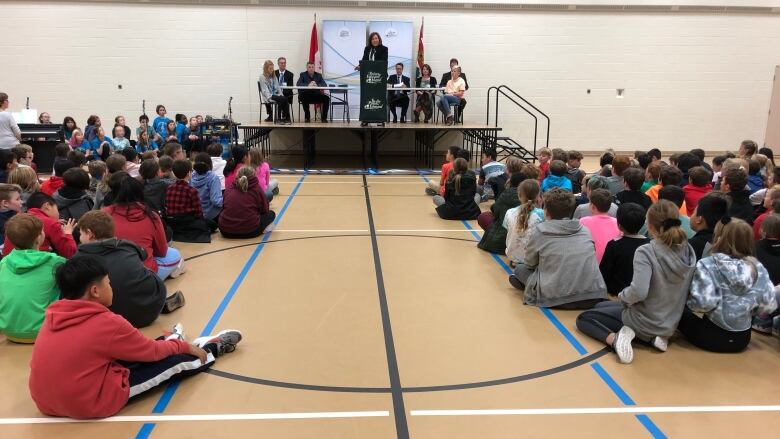 Students gathered and sitting on the floor of the gymnasium at Stratford Elementary School.