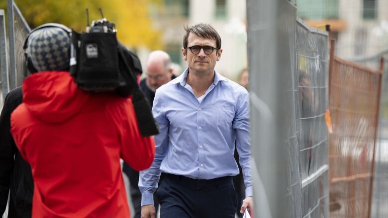 Cameron Ortis, a senior intelligence official at the RCMP, is seen leaving the courthouse in Ottawa Oct. 22, 2019. Ortis is accused of violating the Security of Information Act.