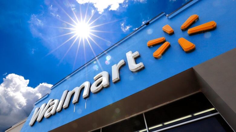 A closeup of a Walmart building against a sunny sky. 