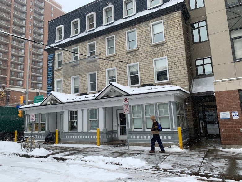 A brick low-rise building in a city in winter.