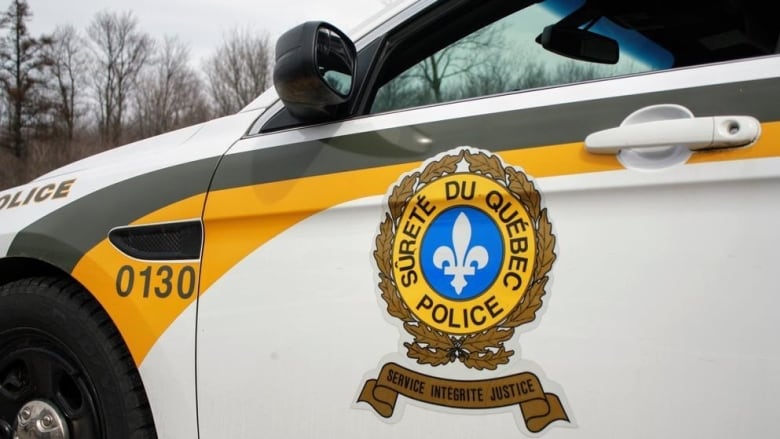 A close-up image of a Quebec police car with the logo on the door. 