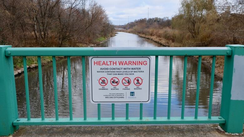 A sign on a bridge.