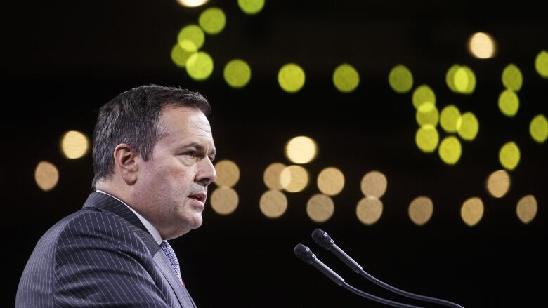 A man speaks at a podium.