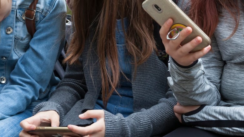 Women using their phones.