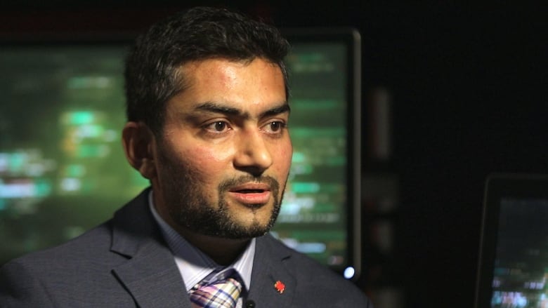 A man sits in a TV studio.