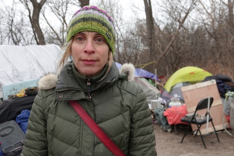 A woman looks into the camera.