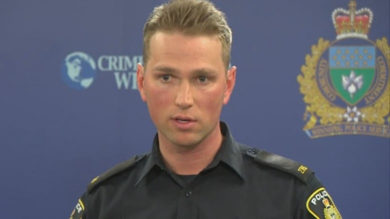 A police officer at a news conference.