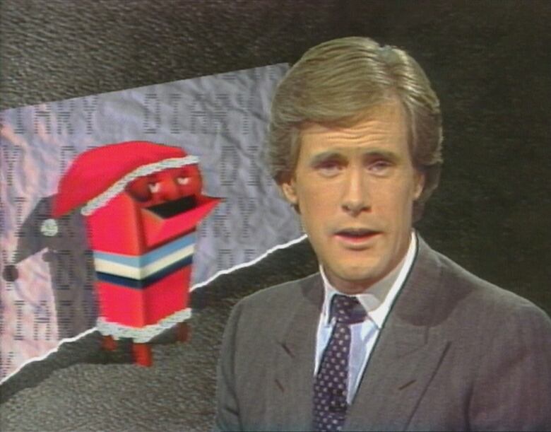 CBC News anchor in front of graphic of Canada Post mailbox with a face wearing a Santa hat