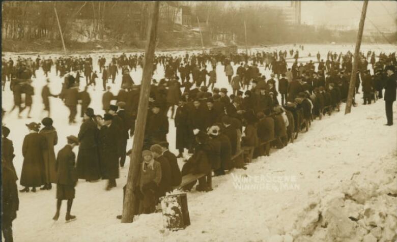 Black and white photo of people skating on a river