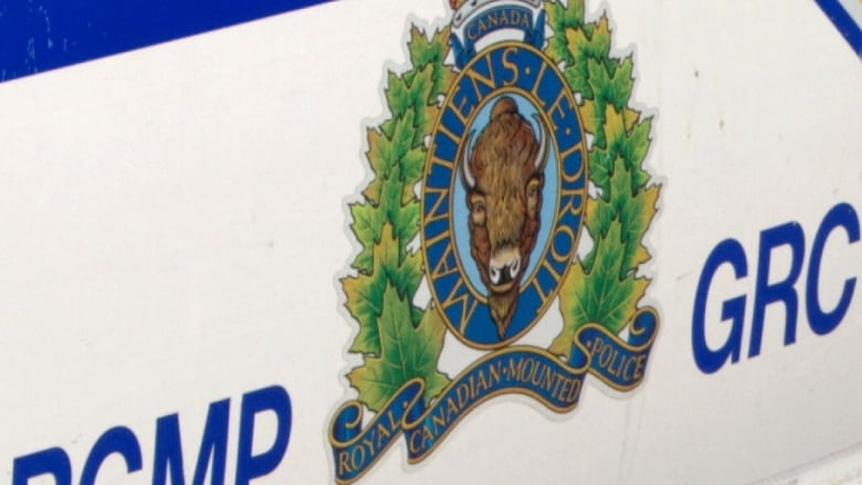 An RCMP logo and wordmark on the side of a police van.