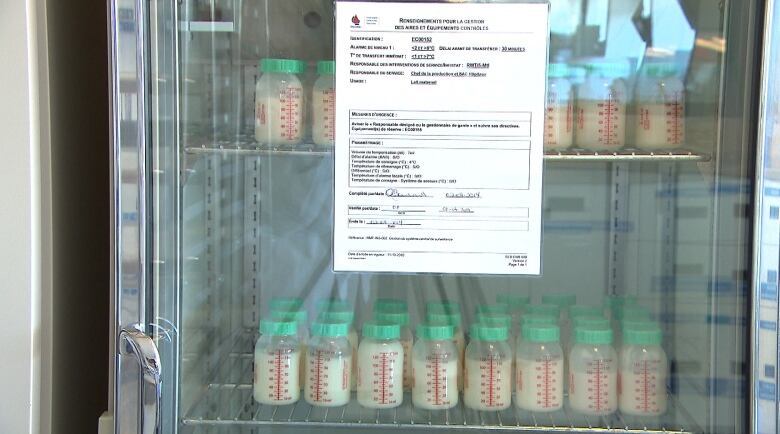 Donated bottles of breast milk in a fridge. 