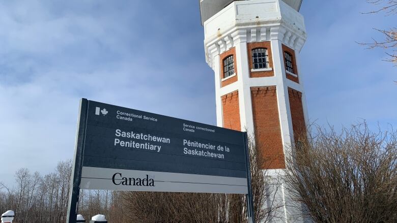 large building with sign in front of that holds prisoners.