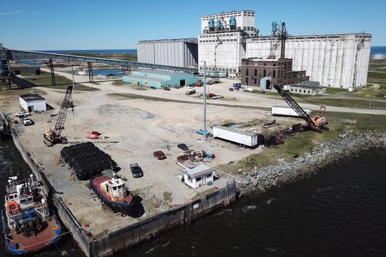 An aerial shot shows a large industrial port.