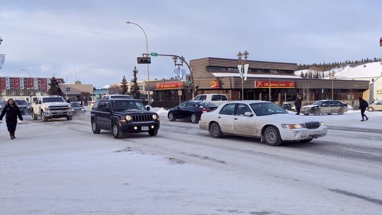 A busy downtown intersection on a winter's day. 