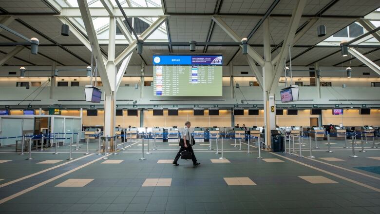 A passenger walks through an empty floor at Vancouver's International Airport. 