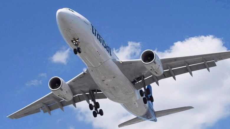 An airplane in flight seen from a low angle.