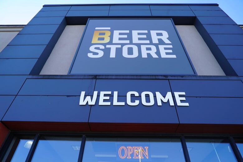 Facade of Beer Store, with signs saying 'Welcome