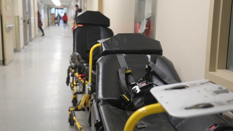 A stretcher sits in a hallway.