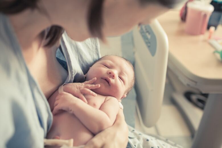 A baby and mother are seen in hospital in this stock photo.