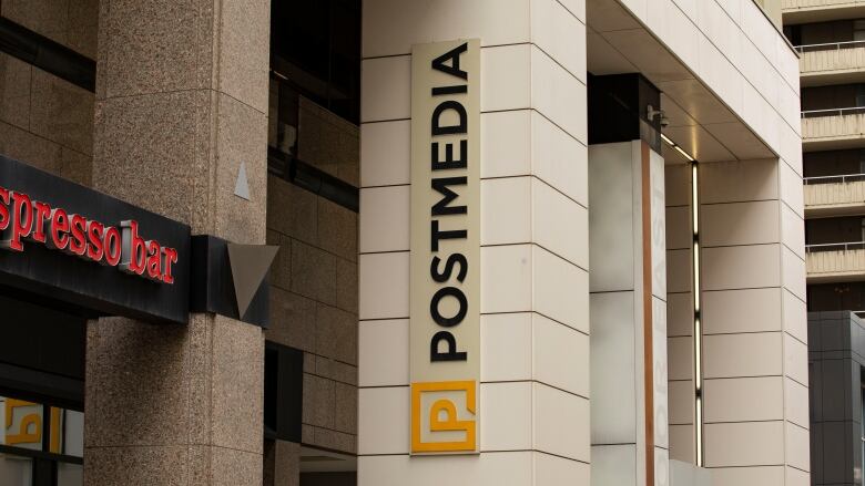 A sign reading 'Postmedia' is seen on a building.