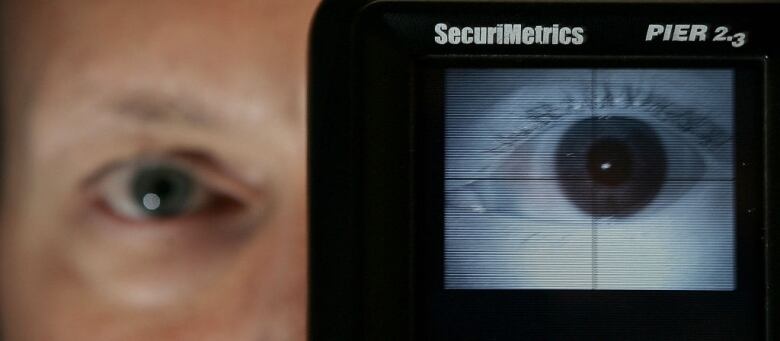 A device scans someone's eyeball.