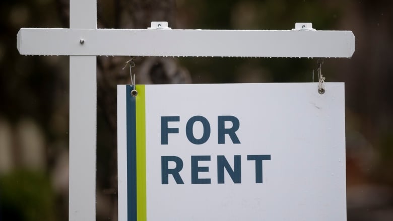 A rental sign is seen outside a building