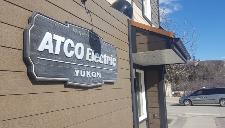 A sign on a building in daylight reads ATCO Electric Yukon