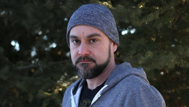 A man with a beard wearing a grey beanie