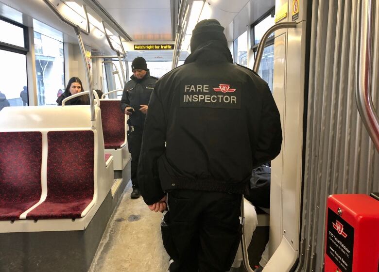 Fare inspectors on the King streetcar in Toronto.