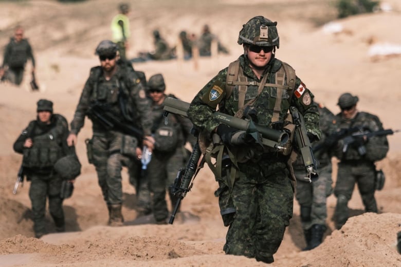 A Canadian soldier carries spent light anti-tank weapons following the conclusion of Exercise Steele Crescendo, which took place outside of Riga, Latvia, in 2020.