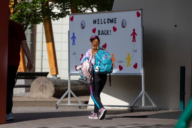 Students are pictured being welcomed back to school with physical distancing protocols in place at Lynn Valley Elementary in North Vancouver, B.C., on June 1. 