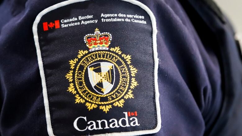 A Canada Border Services Agency (CBSA) patch is seen on an officer in Calgary, Alta., Thursday, Aug. 1, 2019. 