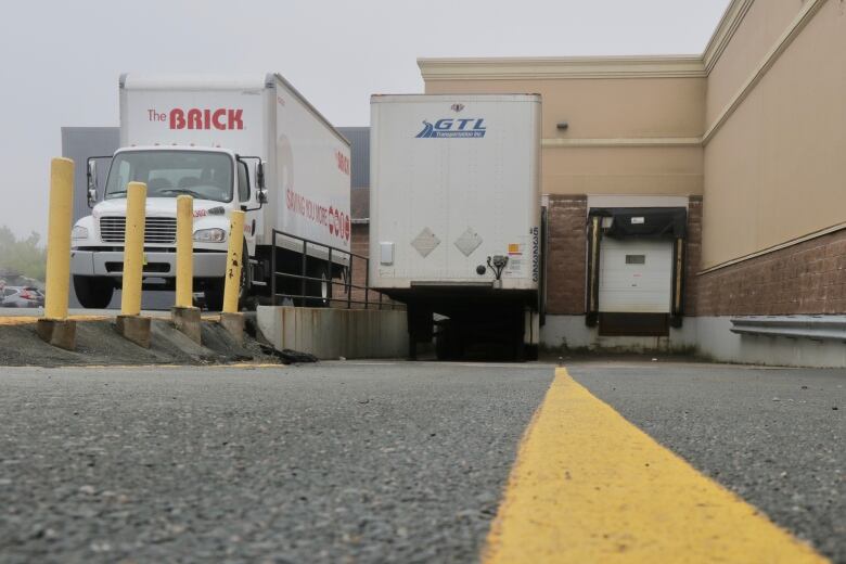 Trucks are shown at a loading bay.