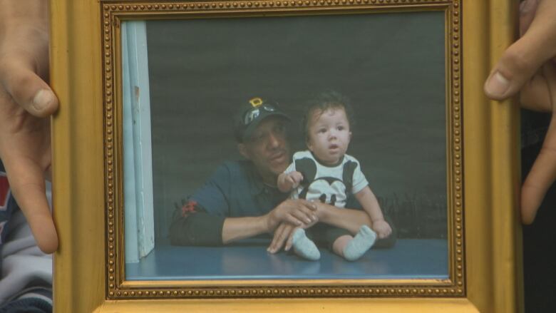 A photograph of a man and child is shown.