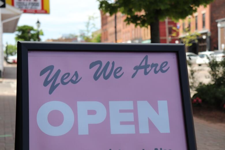 A sign outside a shop that reads 