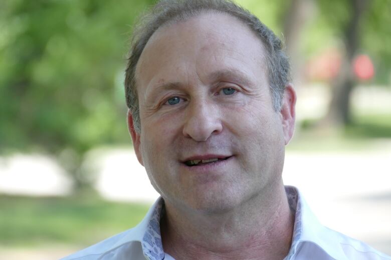 A portrait of man wearing a polo shirt.