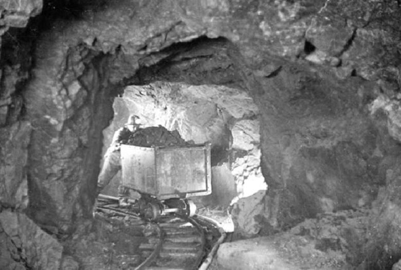 A miner hauls a car of uranium ore at Eldorado Mine in Great Bear Lake, N.W.T. in the 1930s. 