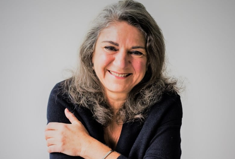 A headshot of a woman smiling.