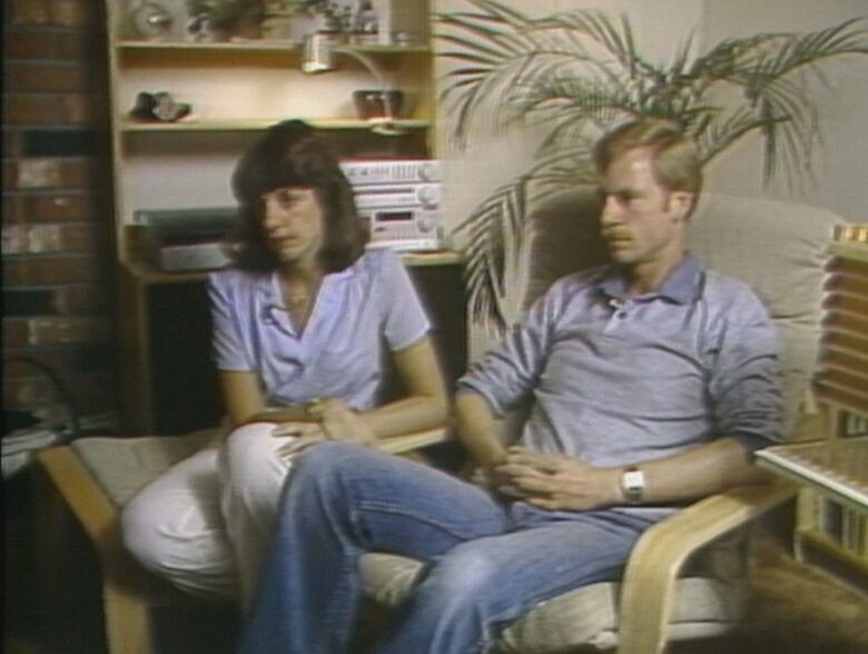 Woman and man in very 1980s living room