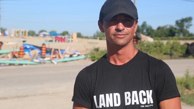 Indigenous activist wearing a Land Back shirt 