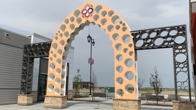 A decorative arch is pictured on a sunny day.