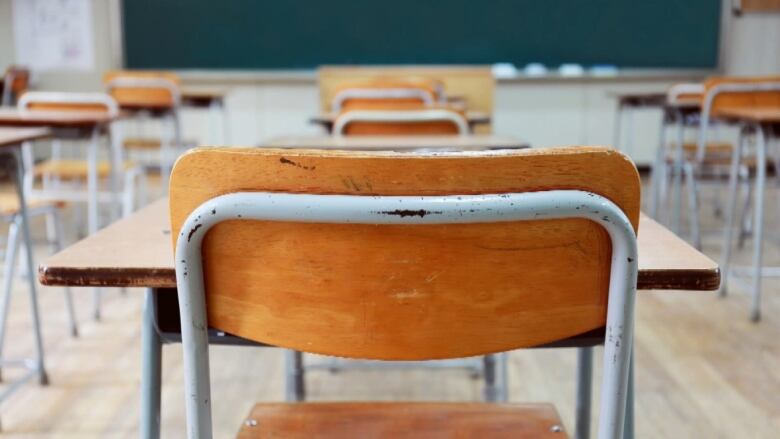 A chair and desk in a classroom.