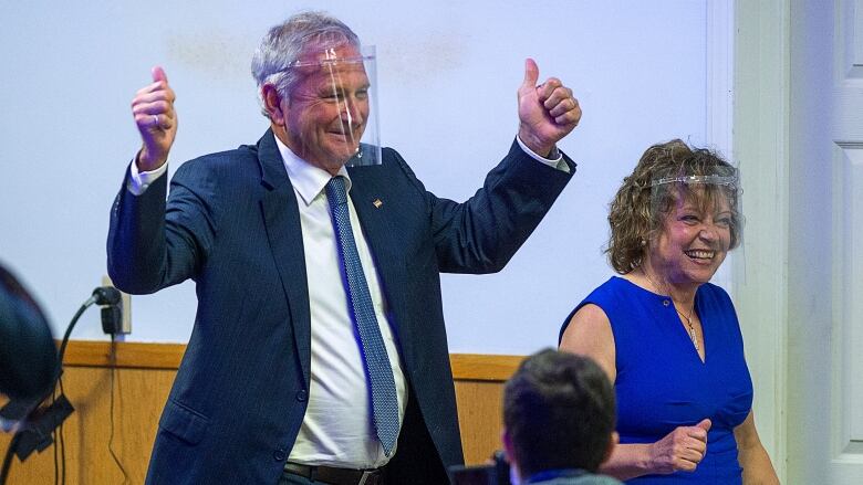 Blaine Higgs, wearing a face shield, gives a double thumbs up.