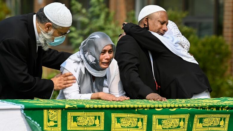 Daughter Bebe Zafis, second left, and family members react at her fathers casket during the funeral of Mohamed-Aslim Zafis in Toronto on Wednesday, September 16, 2020. Police say Zafis was fatally stabbed by an unknown suspect while he sat outside the mosque as he controlled entry to the building in order to comply with public health protocols.