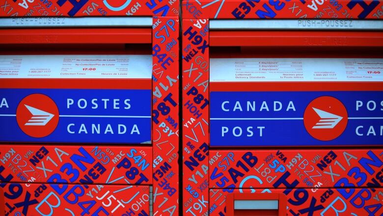 Two bright red Canada Post mailboxes.