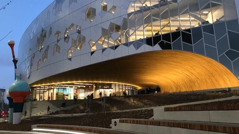 A warm glow reflects the wood used in the arch at the main entrance to the library. 