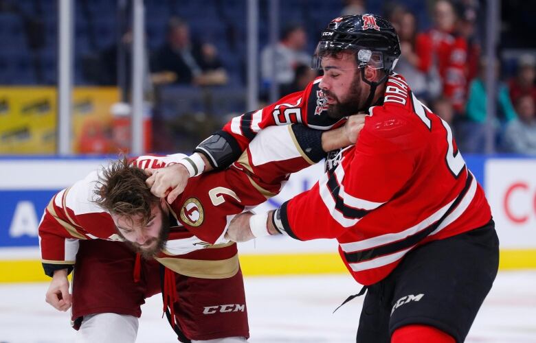 Two hockey players fight 