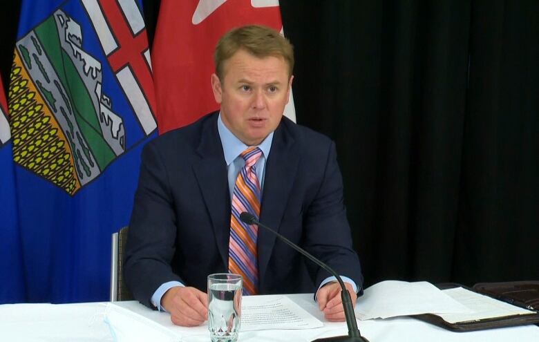 A man sits at a podium.